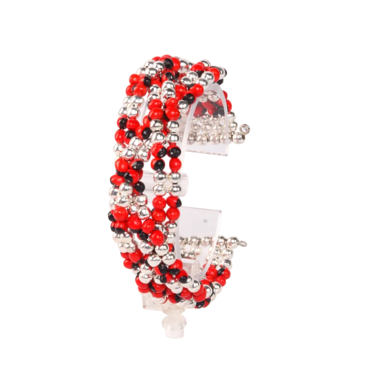 A beaded cuff bracelet with red, black, and silver beads, displayed on a clear acrylic stand against a plain white background.
